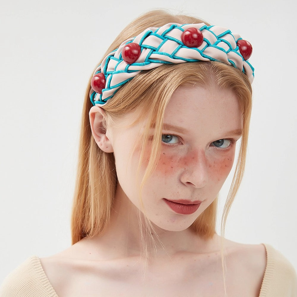 Embellished women's headband in cream with blue braided trim and red bead accents