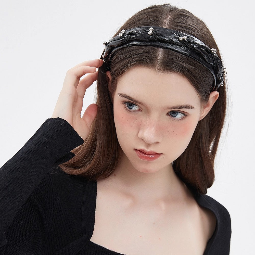 Black embellished women's headband with silver bead details and textured fabric