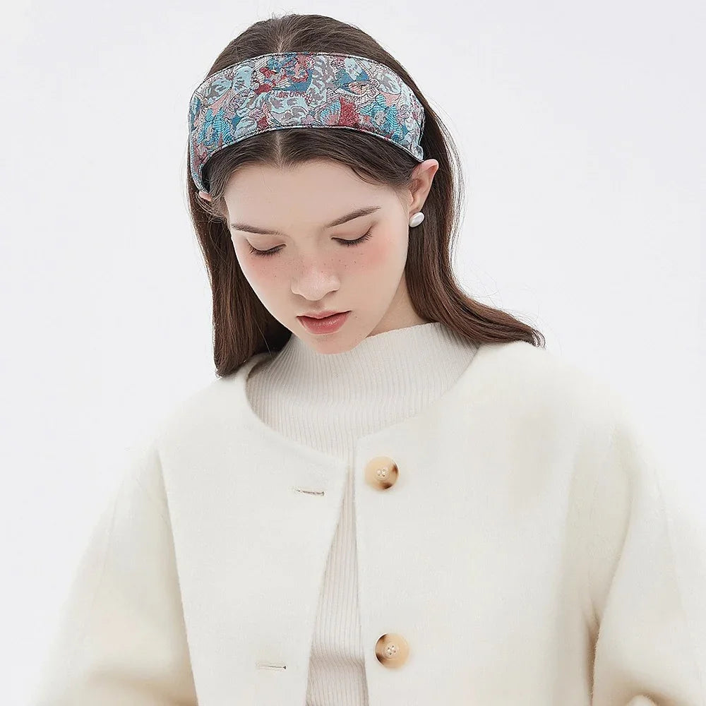 Printed fabric women's headband with floral pattern in blue and red hues, stylish accessory