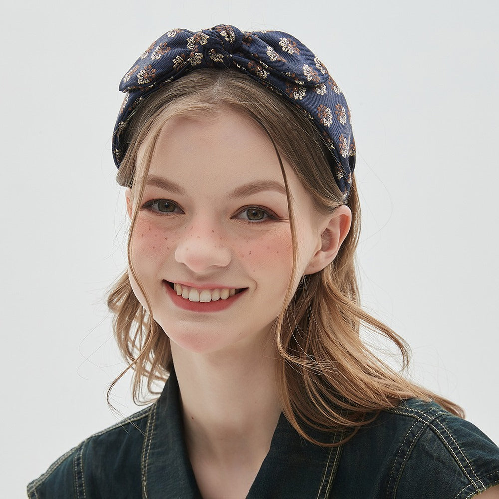 Navy blue floral printed women's bow headband with textured fabric
