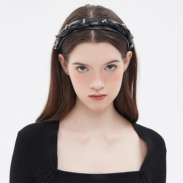 Black embellished women's headband with twisted design and silver bead details