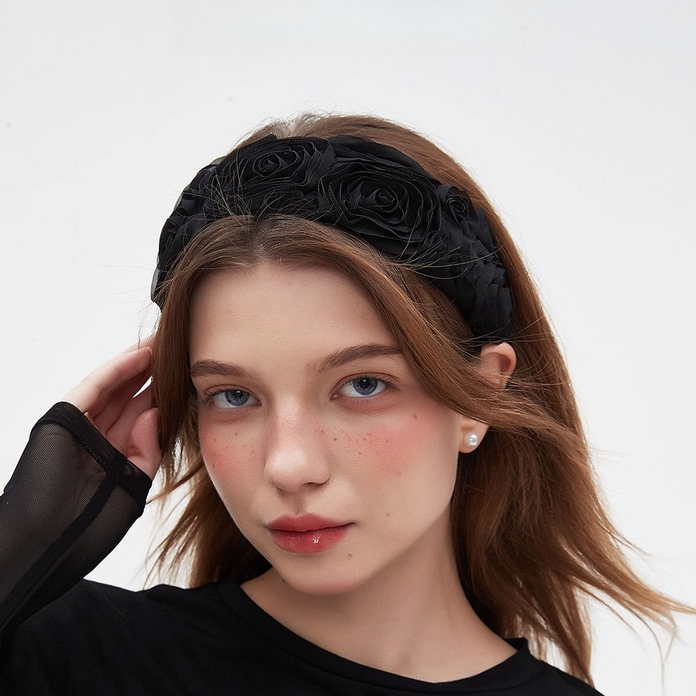 Black embellished women's headband with fabric rose details, elegant floral design