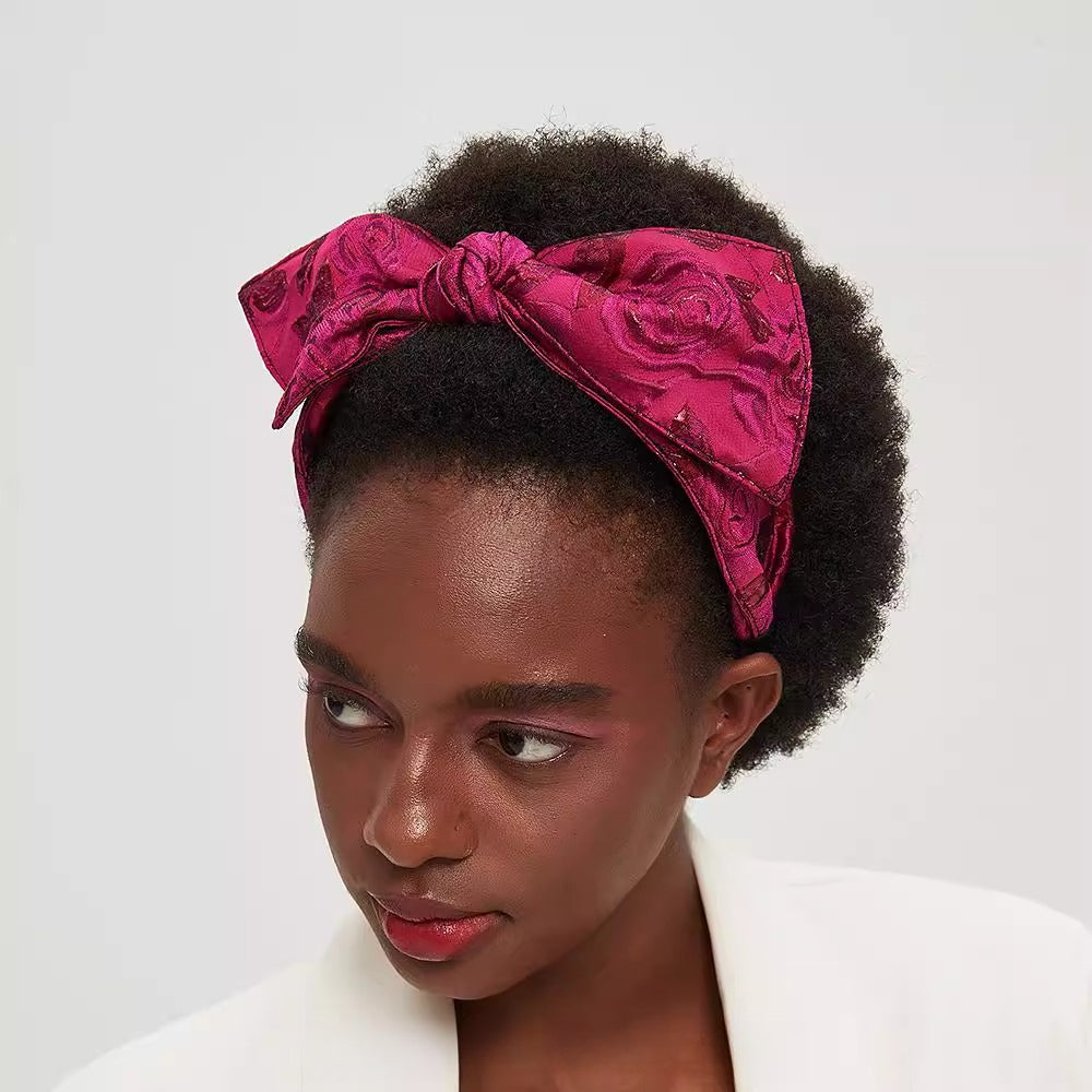 Fuchsia pink bow headband with floral jacquard pattern, embellished women's accessory