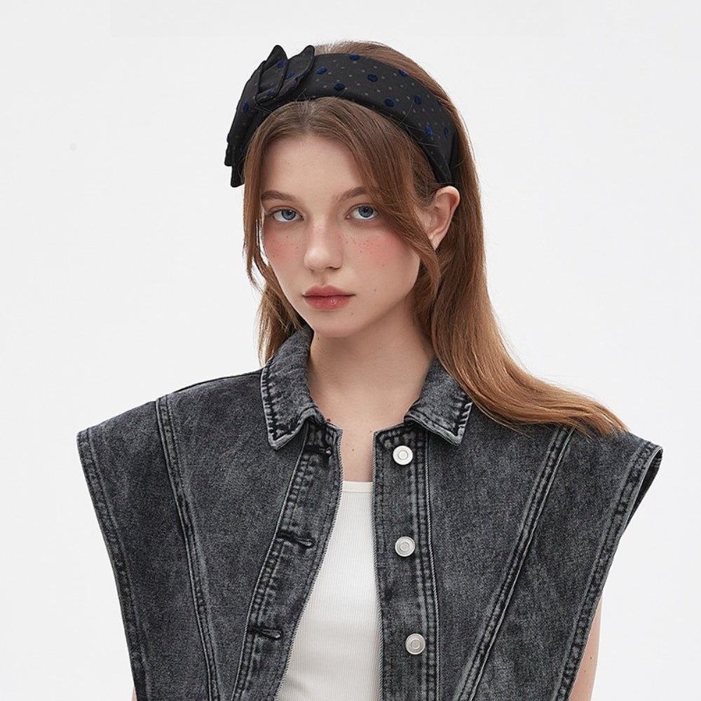Black velvet embellished women's headband with blue polka dots and a decorative bow