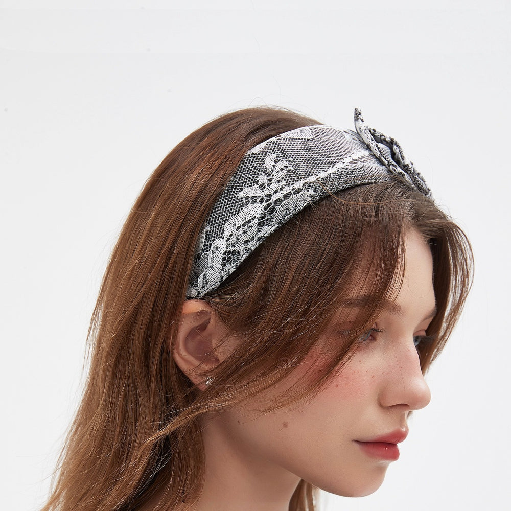 black and white lace embellished women's headband with floral pattern and bow detail