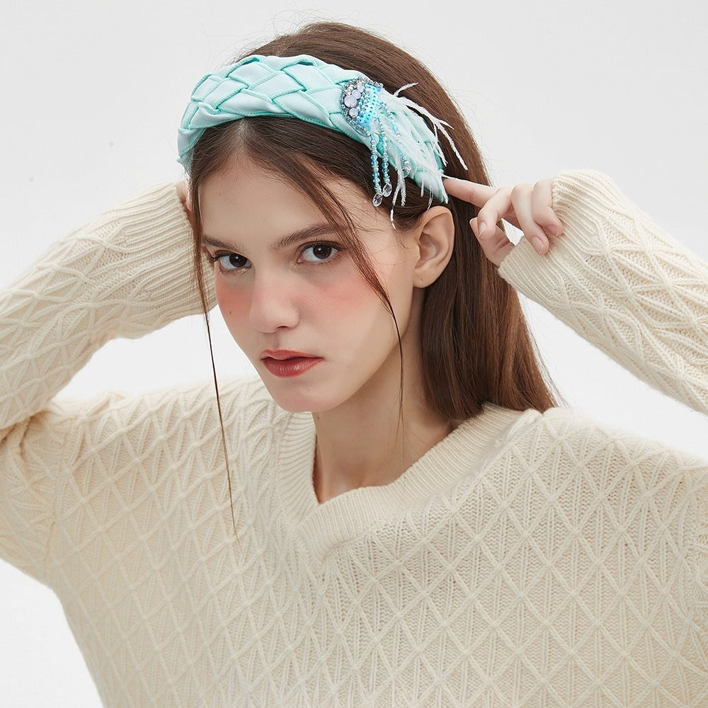 Light blue embellished women's headband with woven texture and bead feather detail