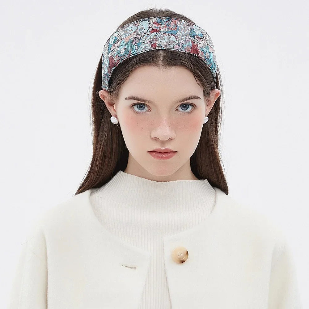 Printed women's headband with blue, red, and white floral pattern, wide fabric style