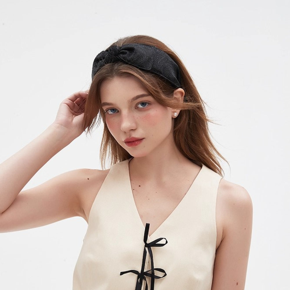 Black fabric bow headband with subtle paisley pattern, women's embellished hair accessory