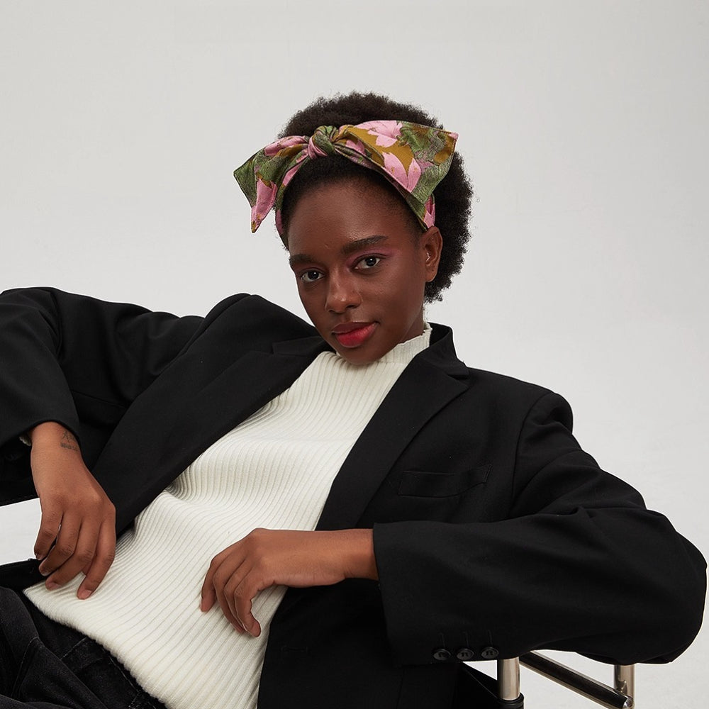 Floral printed bow headband with pink and green leaves on a woman