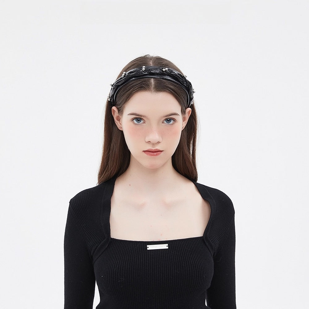 Black embellished women's headband with pearl accents in a minimalist style