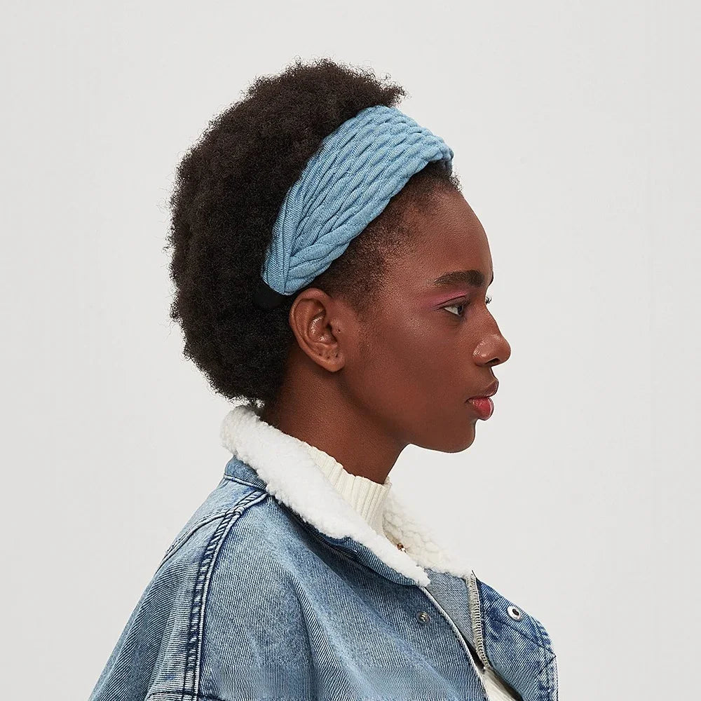 Light blue braided fabric headband in minimalist style worn by woman