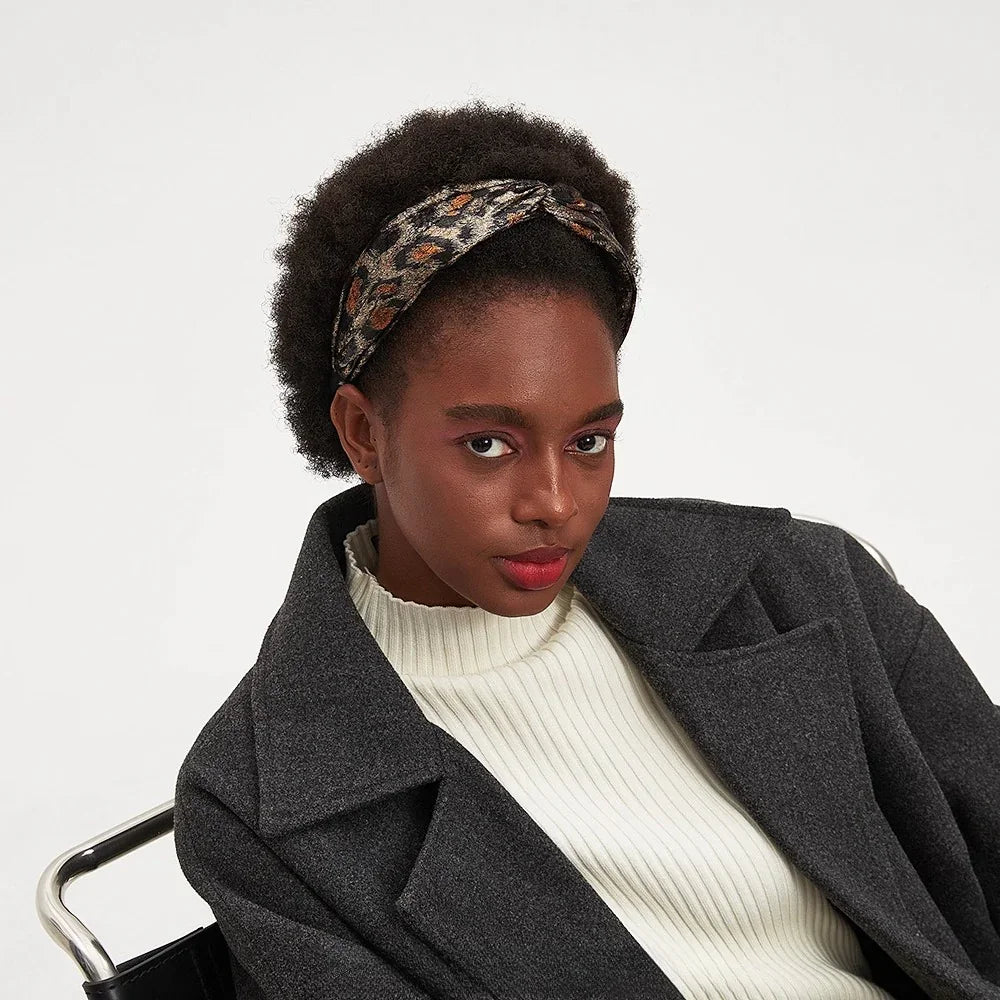 Leopard print bow headband with brown and black spots on fabric