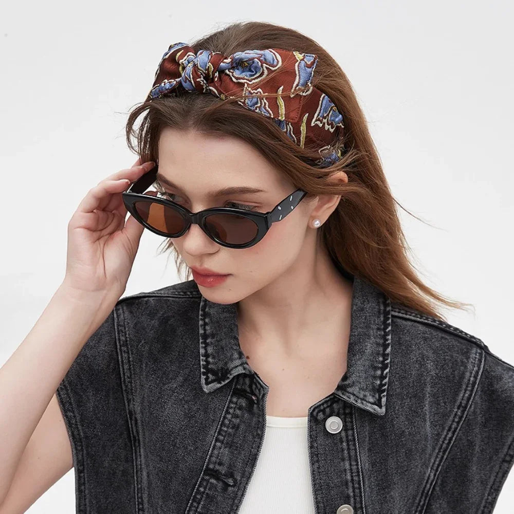 Brown floral printed women's headband with blue flowers in a bow style