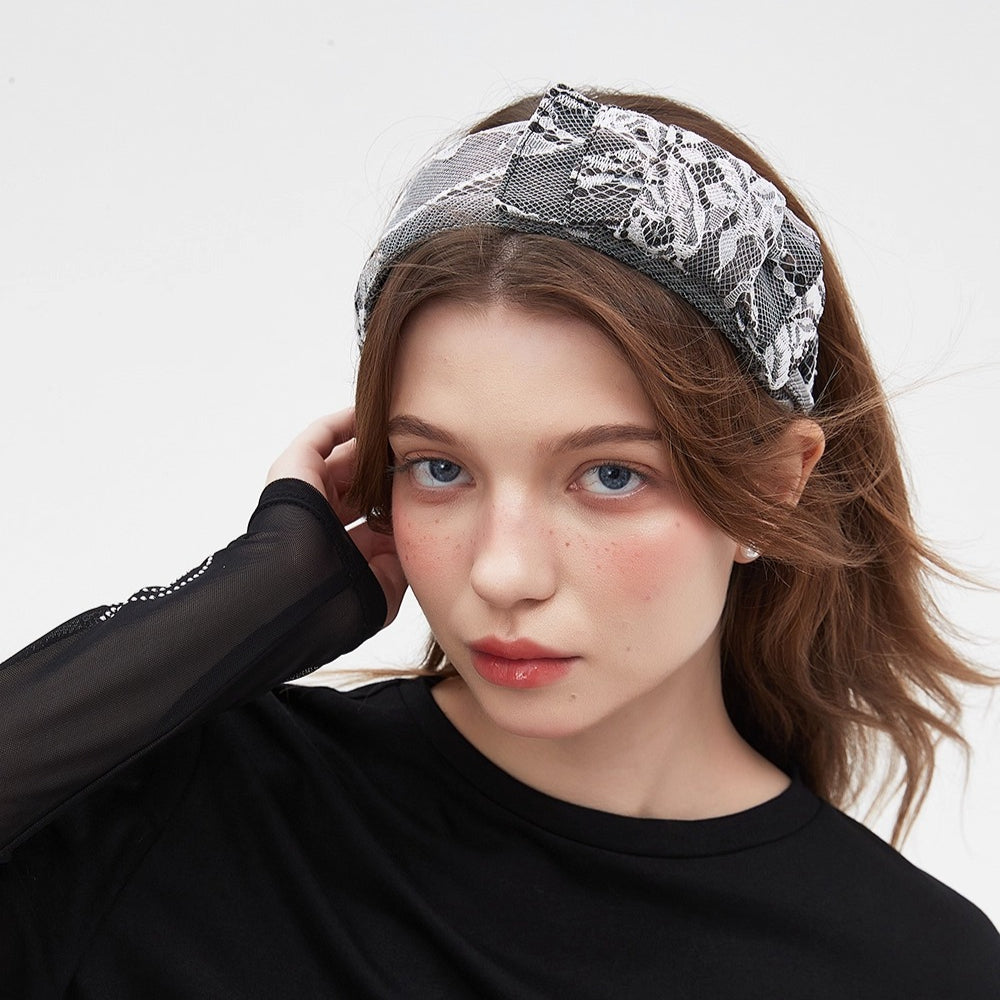 Black and white lace bow headband in embellished style on woman with loose hair