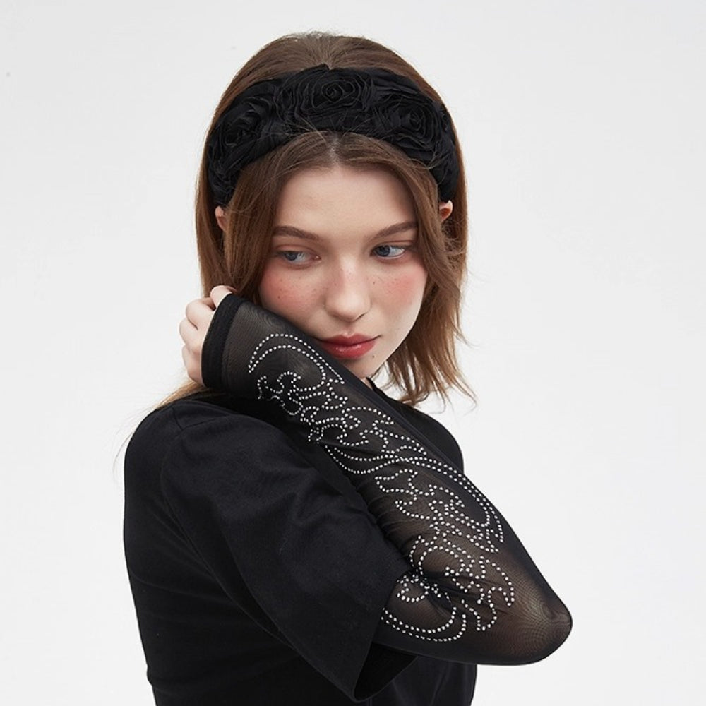 Black embellished women's headband with fabric rose details, floral textured design