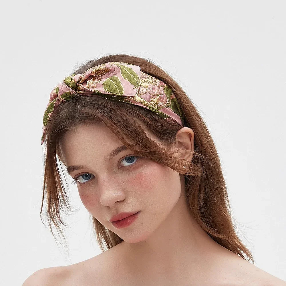 women's pink floral embroidered fabric headband with bow style and green leaf pattern