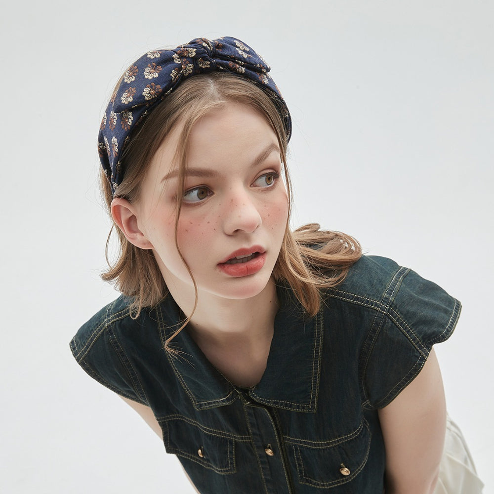 Navy blue printed bow headband with beige floral pattern in satin fabric