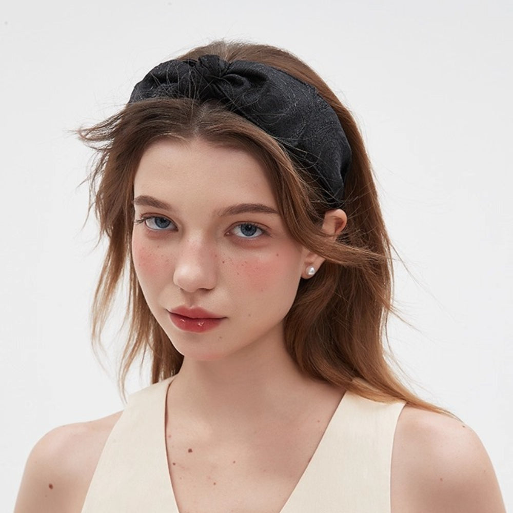 Black fabric bow headband with subtle textured pattern, women's stylish minimalist hair accessory