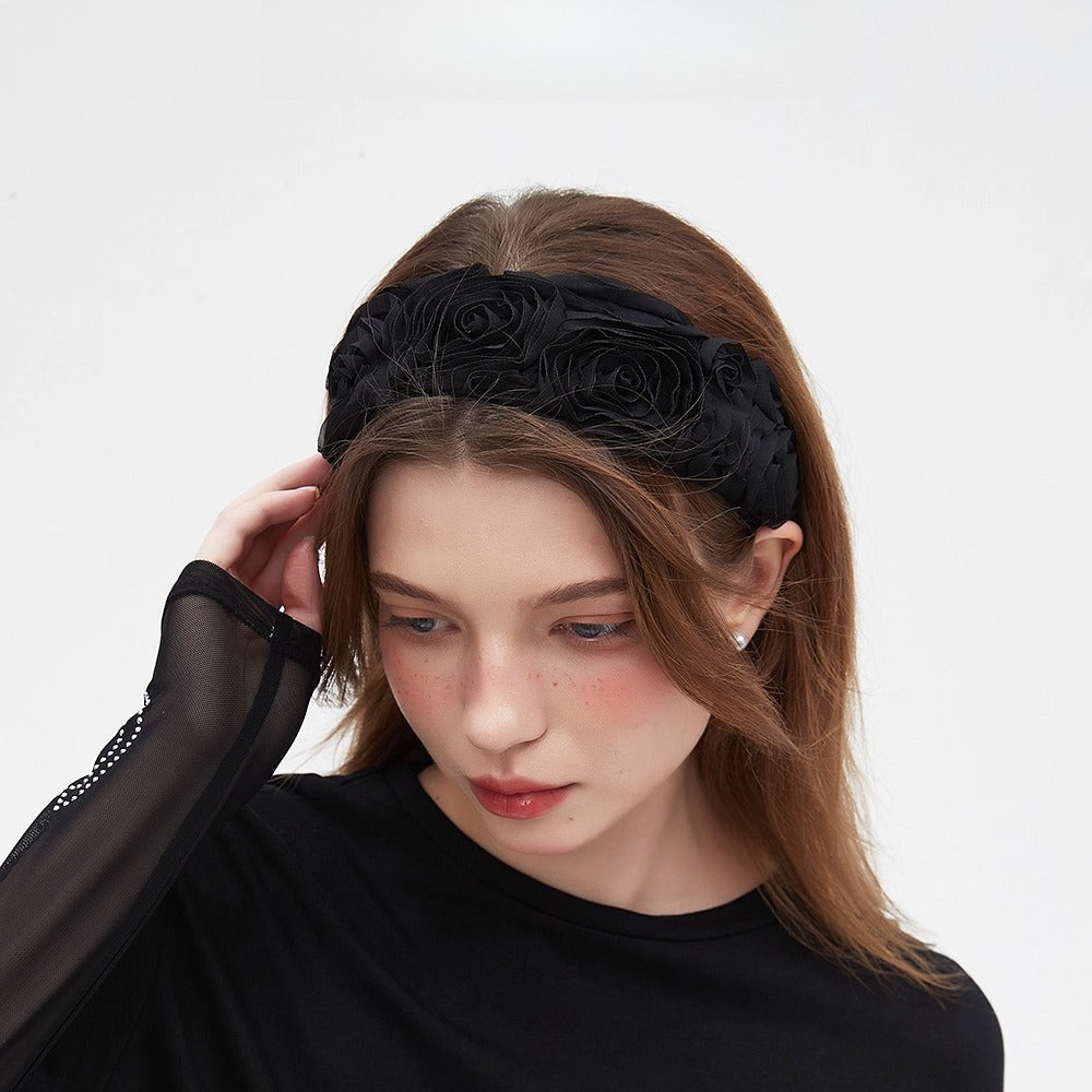 Black embellished women's headband with fabric rose details, floral pattern accessory