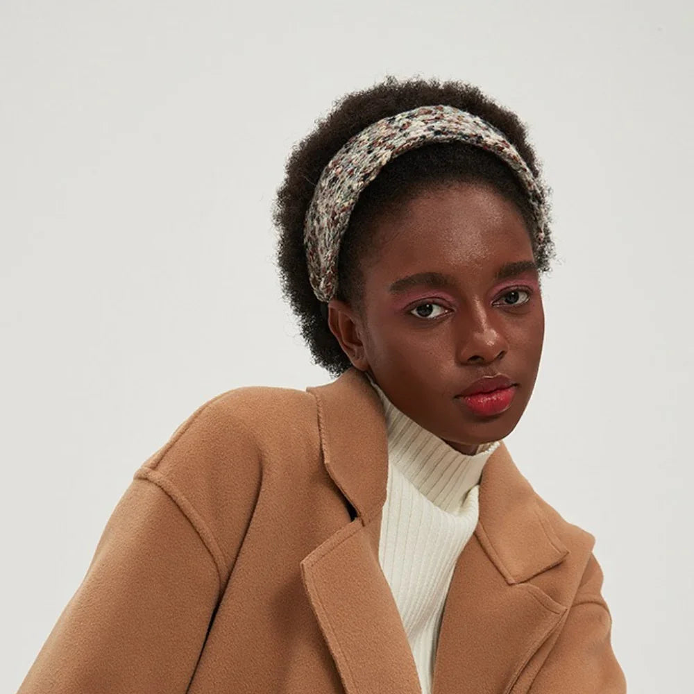 Women's knitted multicolor patterned minimalist headband on model with afro hair