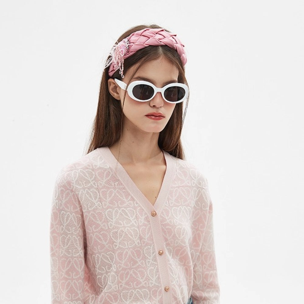 Pink satin braided women's headband with embellishments and feather detail