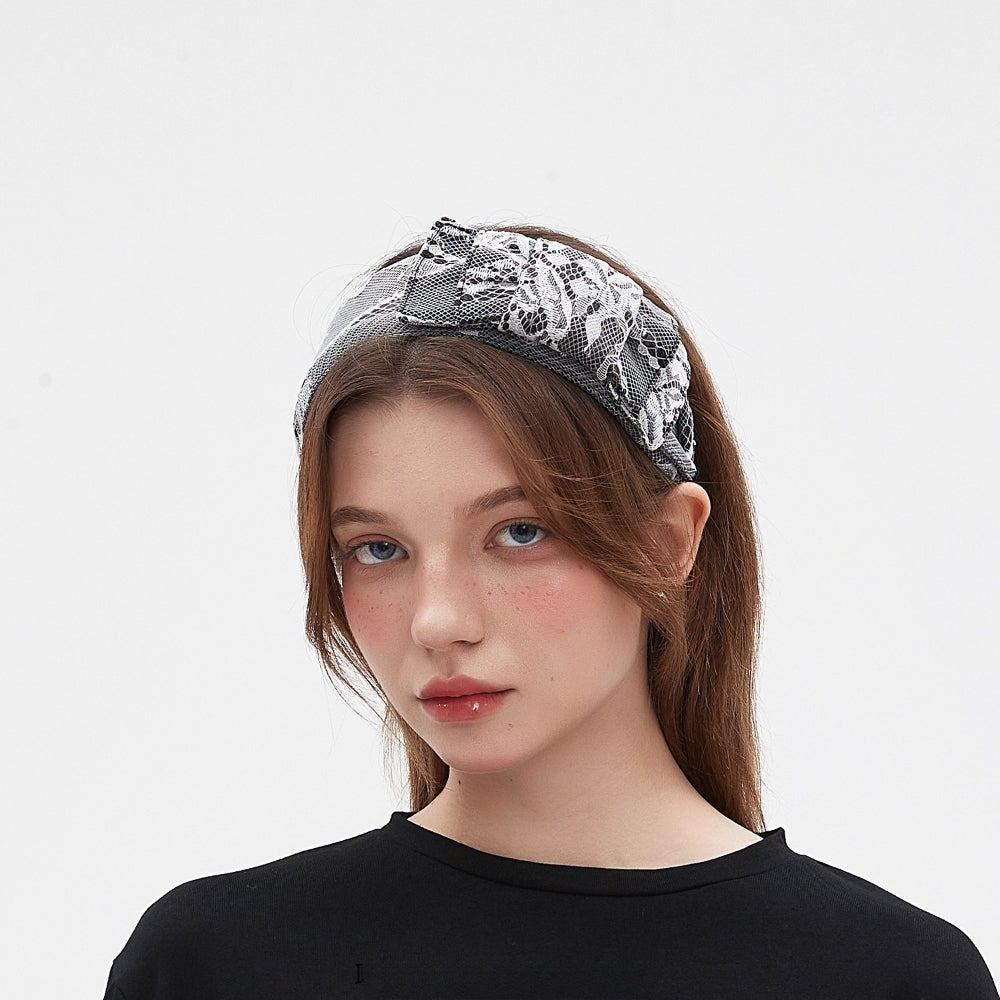 black and white lace embellished women's headband with floral pattern and bow detail