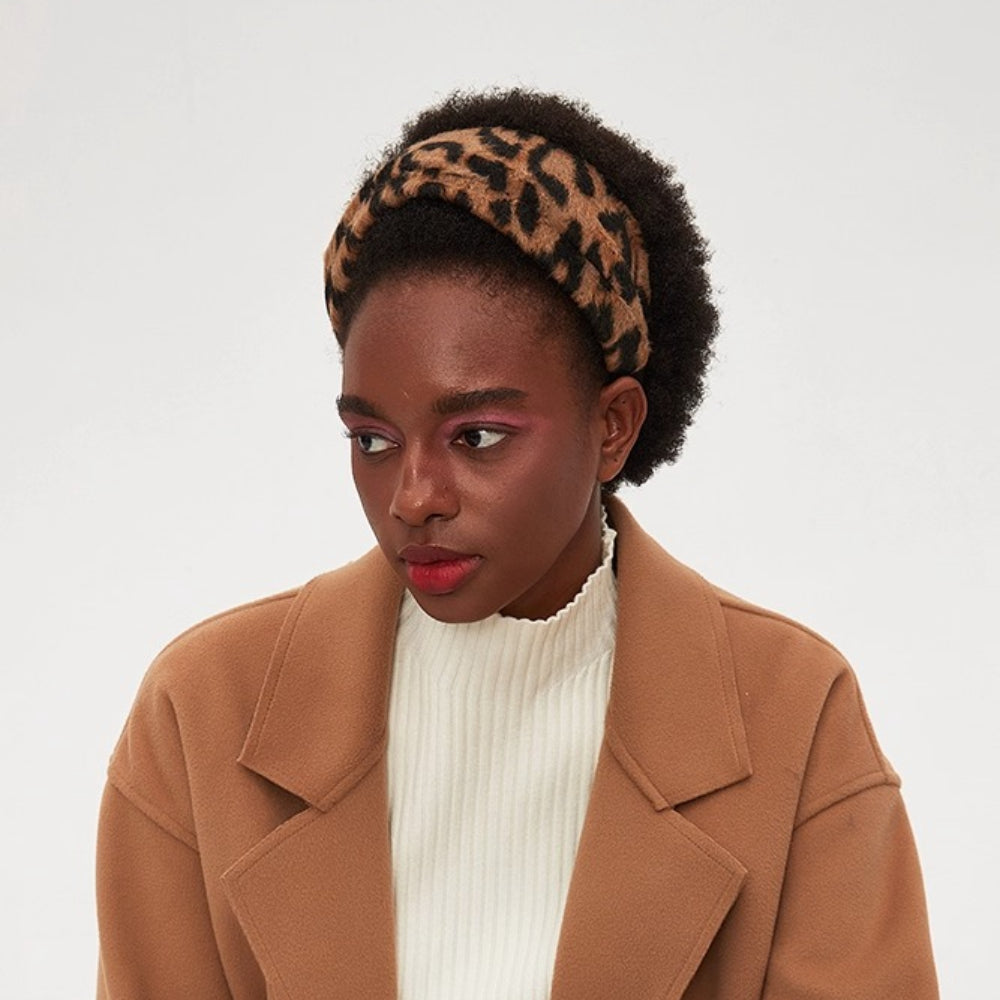 Women's leopard print fabric bow headband with a soft, textured material and bold pattern