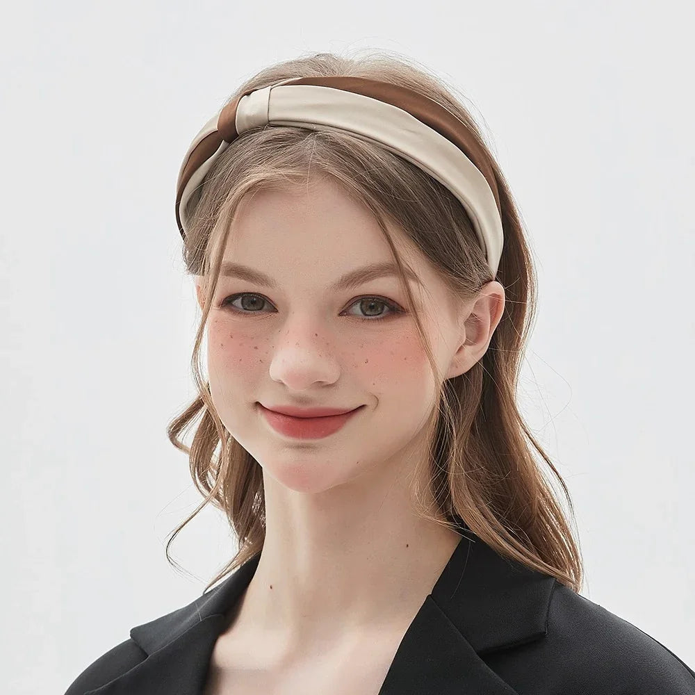 Women's brown and beige bow headband in smooth fabric, minimalist style